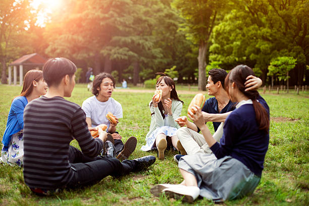 Friends enjoying a relaxed picnic together in a Japanese park